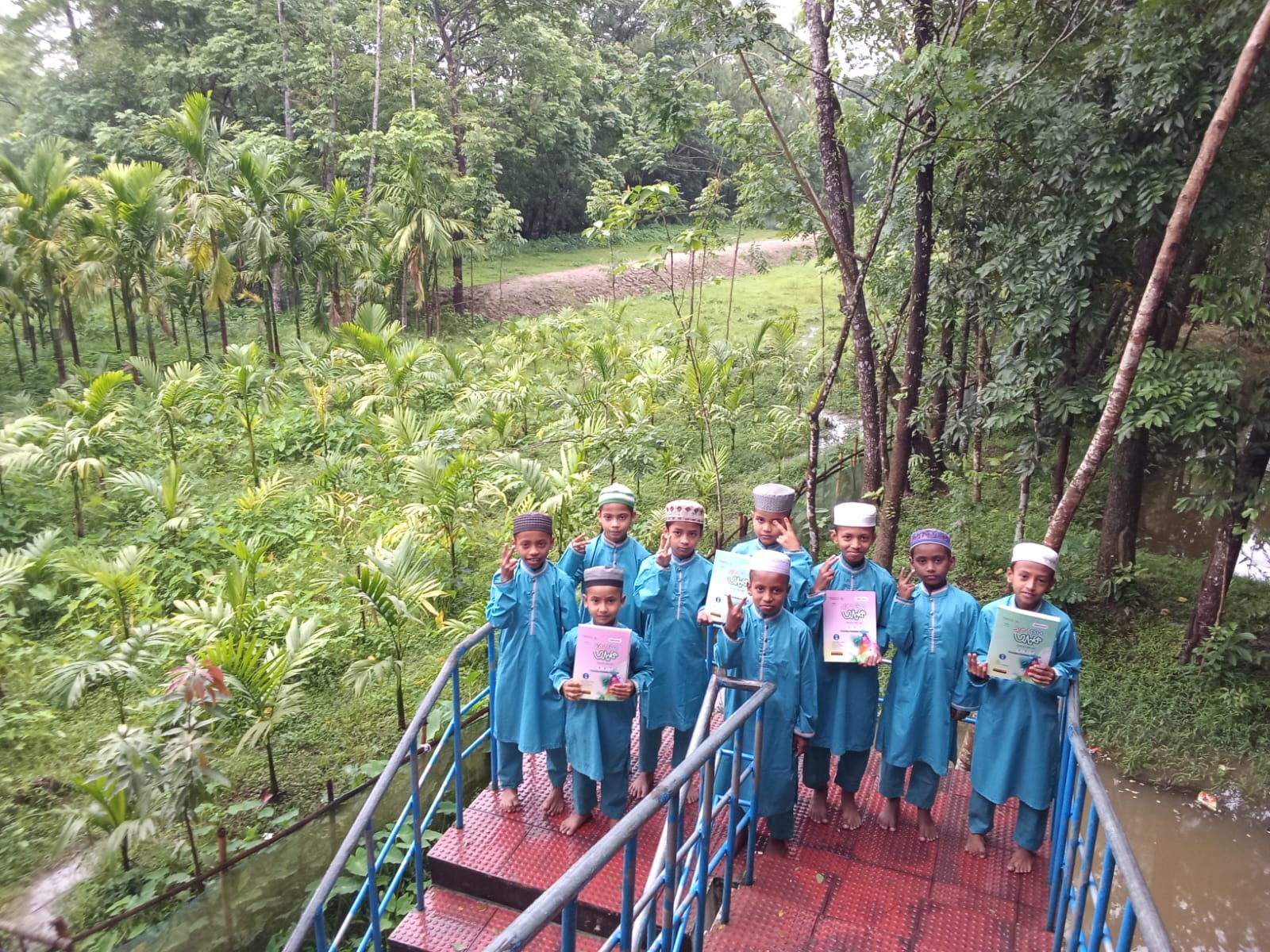 Students holding their books on the bridge
